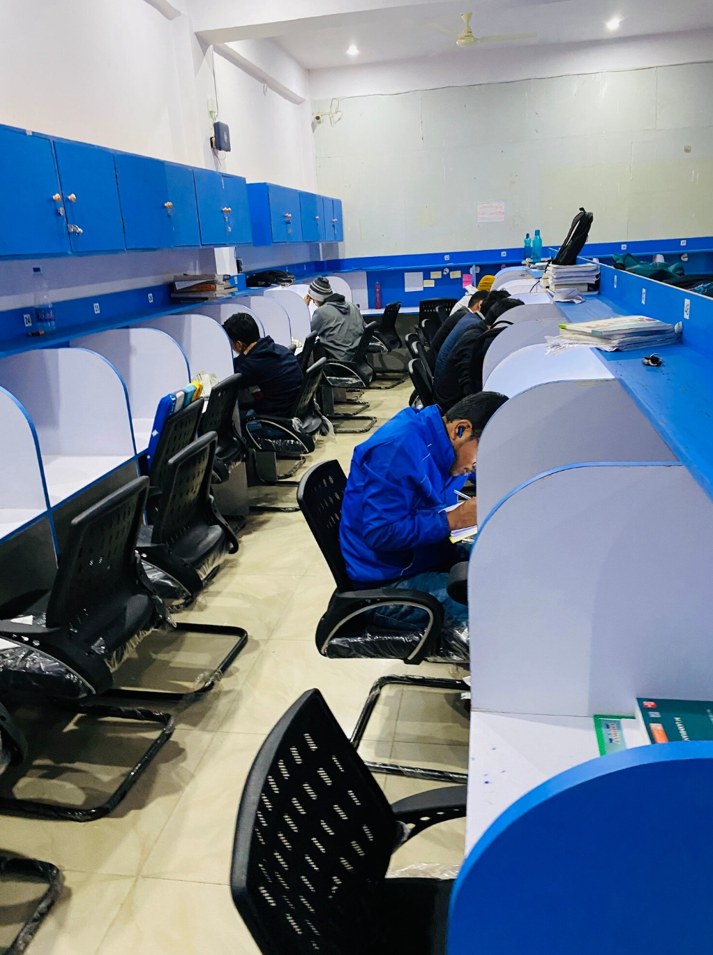 Students studying at individual desks inside Caliber Library